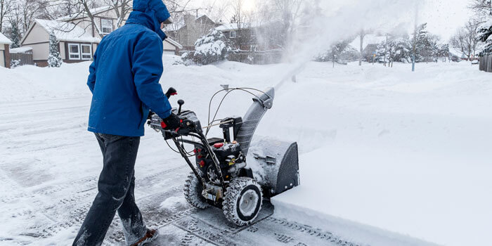 Person Snow Blowing Driveway